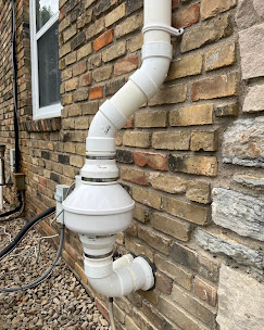 Radon fan on brick exterior